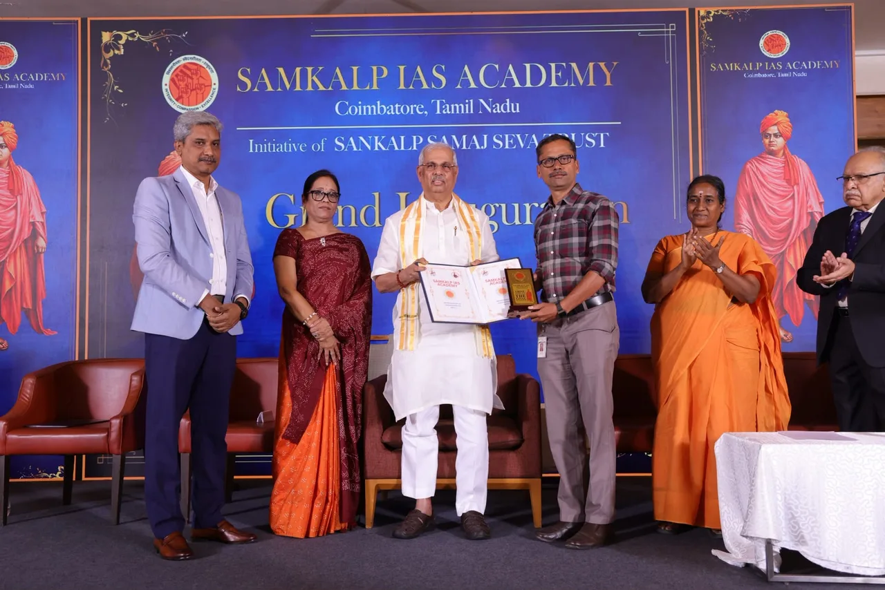 Honourable Dr. Rajendra Vishwanath Arlekar, Governor of Tamil Nadu, handing over the signed MoU between Samkalp IAS Academy and Hindustan Arts and Science College, Coimbatore, on the inauguration stage.