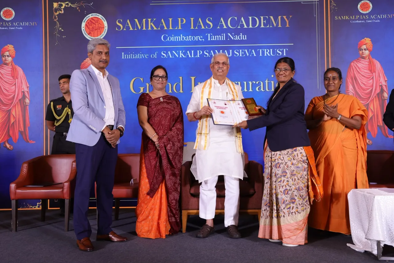Honourable Dr. Rajendra Vishwanath Arlekar, Governor of Tamil Nadu, handing over the signed MoU between Samkalp IAS Academy and Sasurie College of Arts and Science on the inauguration stage.