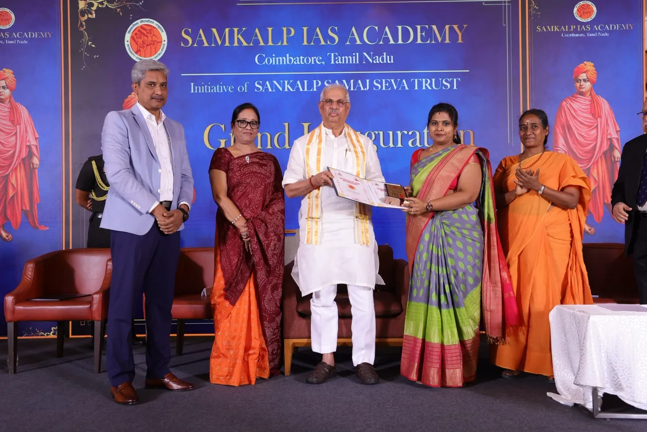 Honourable Dr. Rajendra Vishwanath Arlekar, Governor of Tamil Nadu, handing over the signed MoU between Samkalp IAS Academy and Sasurie College of Engineering on the inauguration stage.