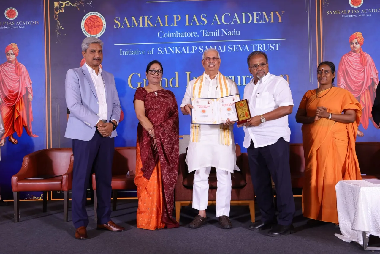 Honourable Dr. Rajendra Vishwanath Arlekar, Governor of Tamil Nadu, handing over the signed MoU between Samkalp IAS Academy and Sri Saraswathi Thyagaraja College, Pollachi, on the inauguration stage.
